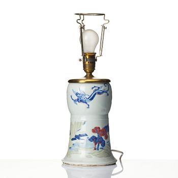 A celadon, copper-red and underglaze blue carved beaker vase, Qing dynasty, Kangxi mark and of the period (1662-1722).