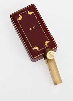A Castier goldplated lipstick case.