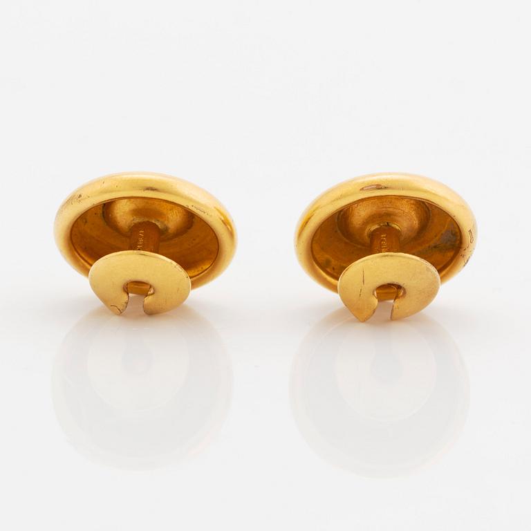 A pair of 18K gold cufflinks set with old-cut diamonds.