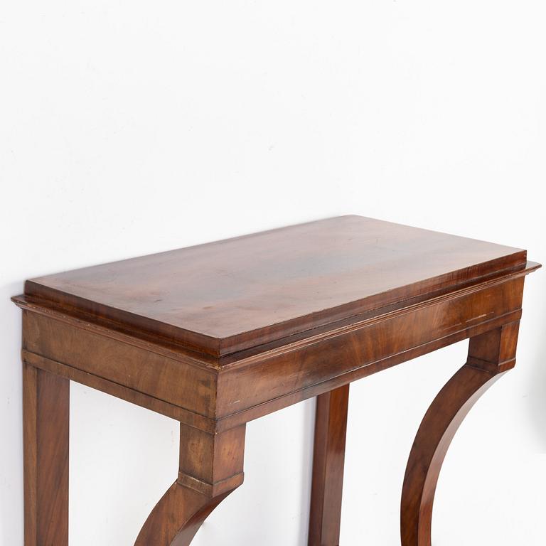A mahogany veneered mirror with console table, first half of the 19th Century.