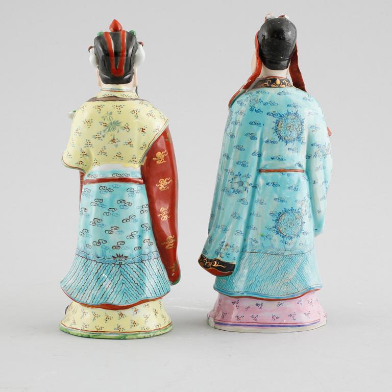 A pair of chinese figurines.