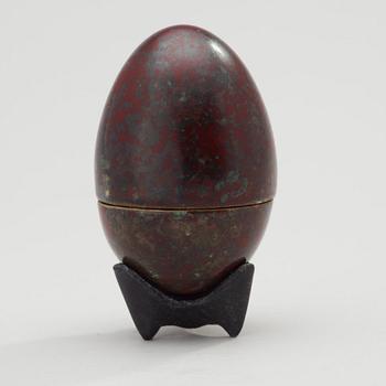A Hans Hedberg faience egg on an iron base, Biot, France.