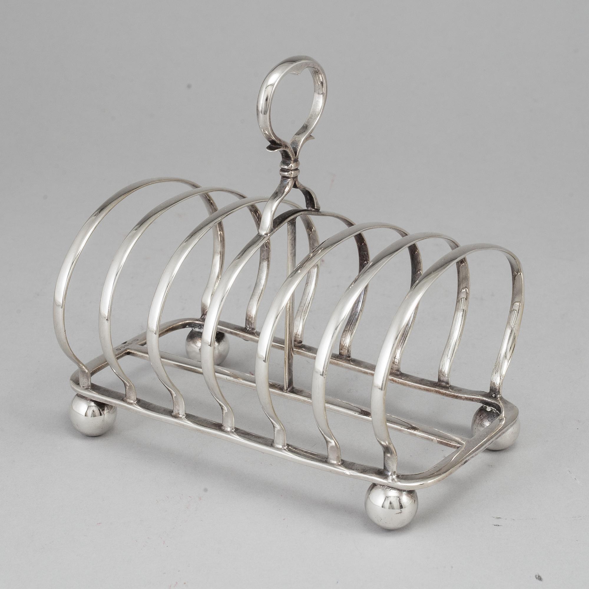 An English 20th century silver-plated toast rack, marked WH.