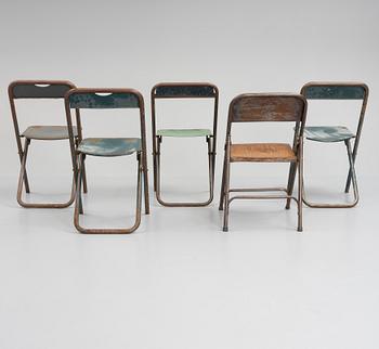 A set of five folding chairs.