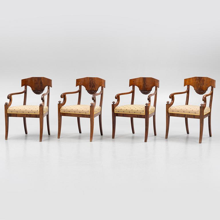 A suite of four Swedish Empire mahogany open armchairs, early 19th century.