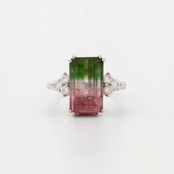 A emerald cut tourmaline and brilliant cut diamond ring.