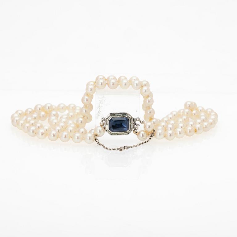 Two-row cultured pearl necklace with a silver and glass clasp.