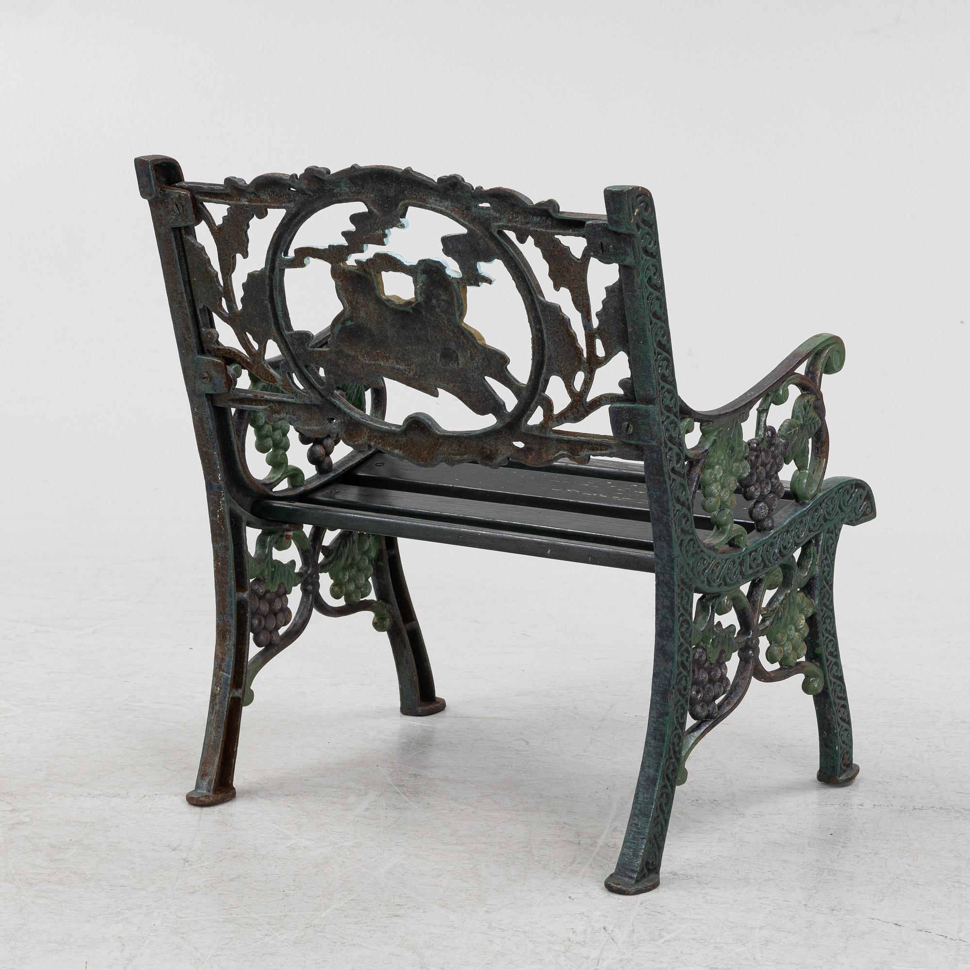 A children's cast iron garden sofa and armchair, mid 20th century.