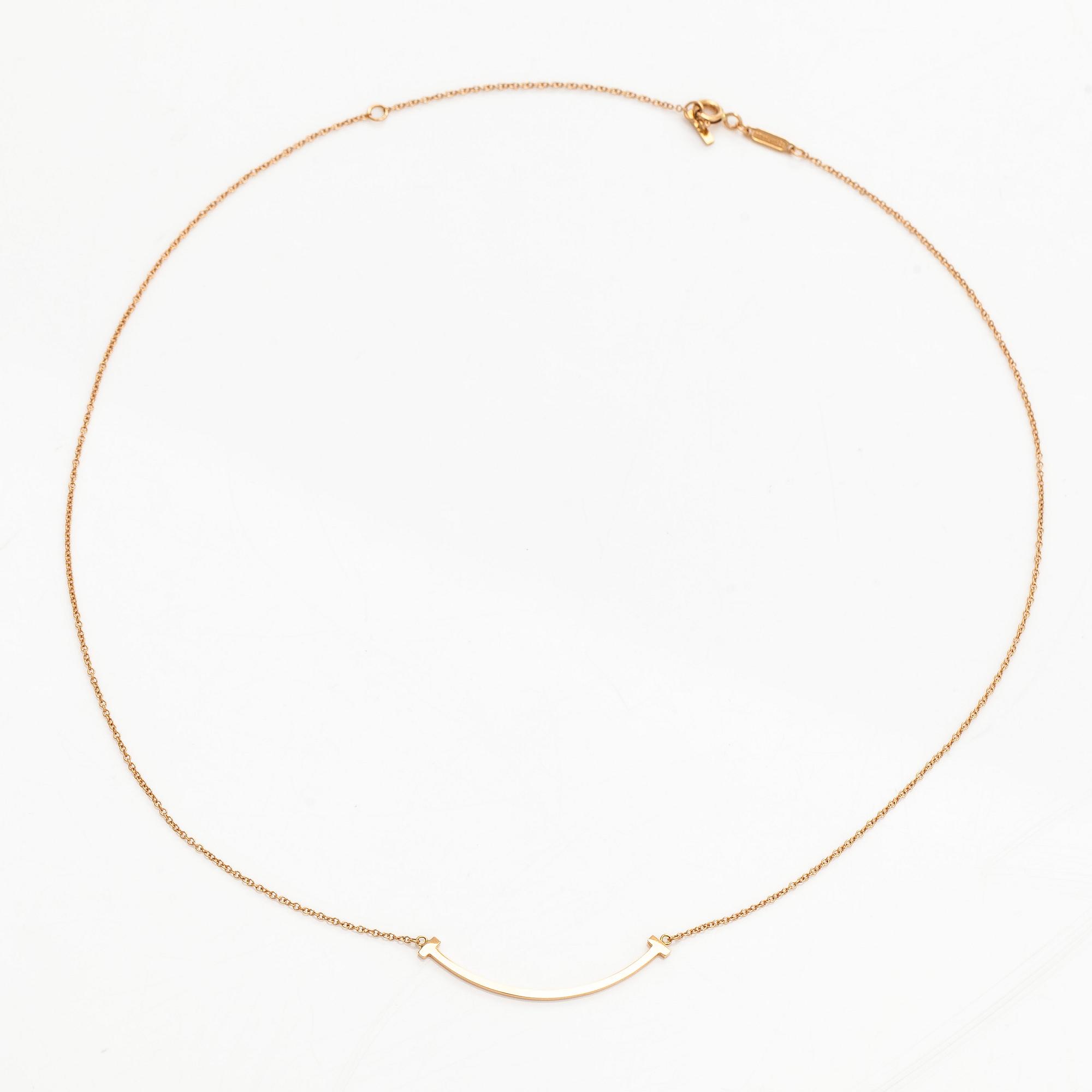 Tiffany & Co, an 18K gold 'T Smile' necklace.