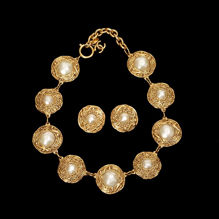 A necklace and a pair of earrings by Chanel.