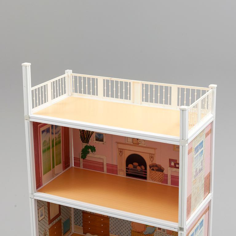A plastic doll's house with six dolls, furniture and clothes, 20th century.