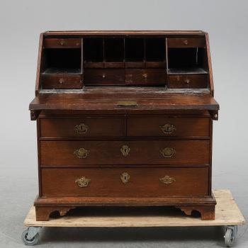 An early 19th century oak secratire.