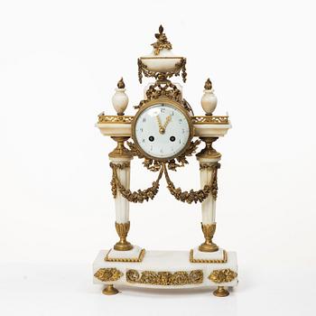 A Louis XVI-style mantle clock and a pair of candelabras. Early 20th century.