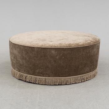 A 21st century upholstered foot stool by Gubi.