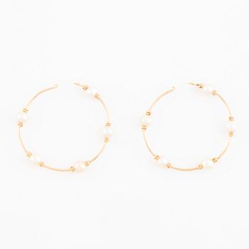 Gold and pearl hoop earrings.