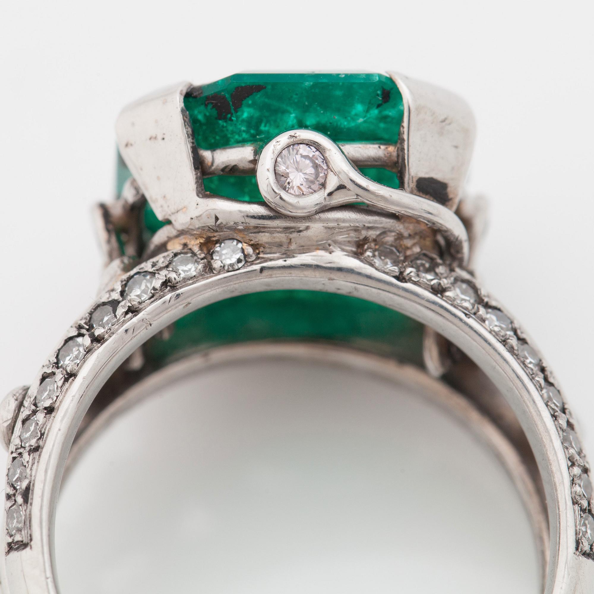 An octagonal cut 6.50 ct emerald and brilliant cut diamond ring. Mandelstam 'Ice Age'.