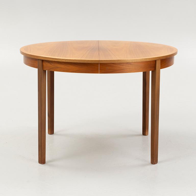 A walnut-veneered dining table, 1960's/70's.