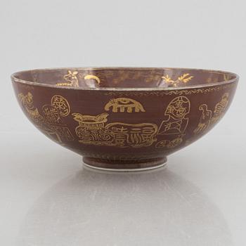 A brown glazed bowl with gilded decoration of animals and antiques, Qing dynasty, 19th century.