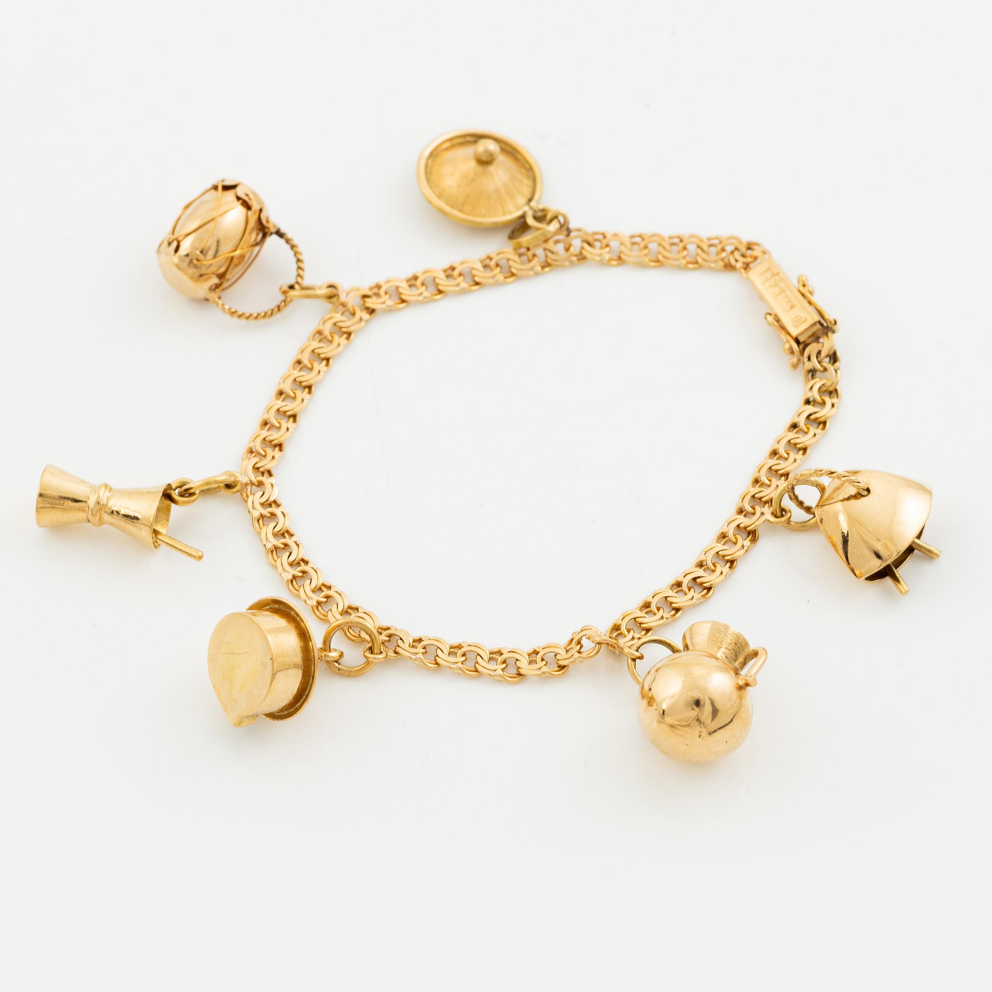 Bracelet, 18K gold bismarck link. With charms.