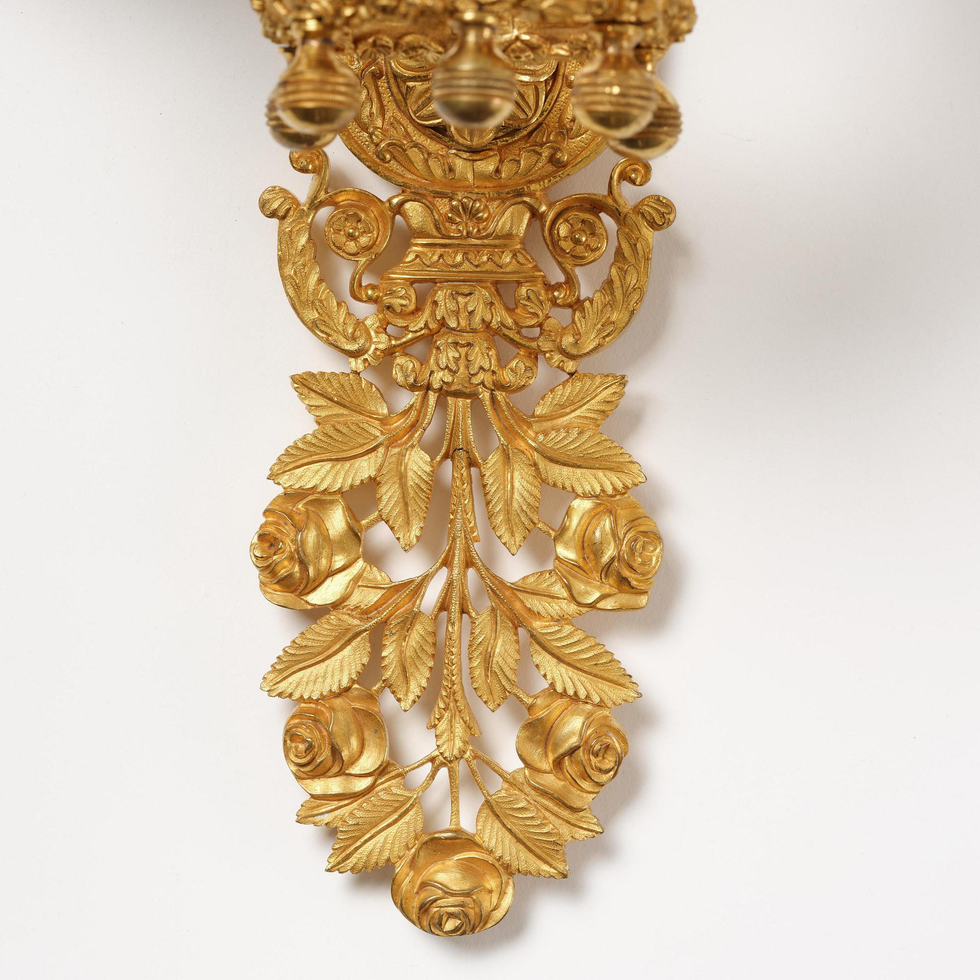 A pair of French 19th century gilt bronze five-light wall-lights.