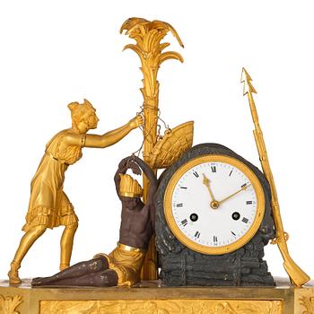 A figural Empire ormolu and patinated bronze mantel clock, early 19th century.