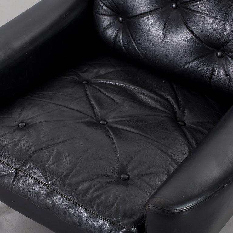 A 1960s Scandinavian black leather easy chair.