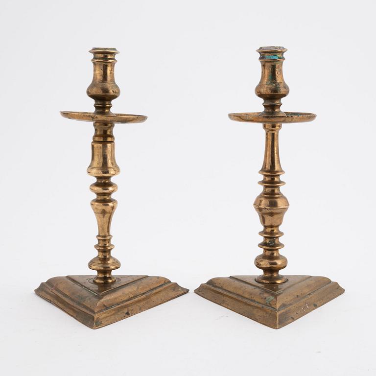 A set of two late baroque style brass candlesticks, 19th Century.