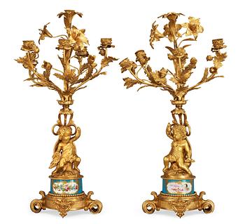 609. A pair of French 1860/70's gilt metal and porcelain six-light candelabra.