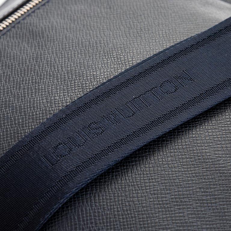 Louis Vuitton, a Navy Taiga 'Sasha' Messenger bag.