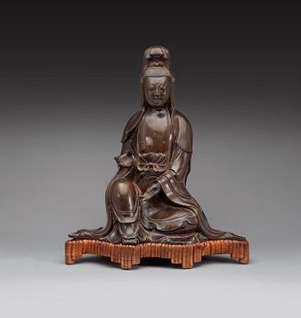 A large bronze figure of a seated Guanyin dressed in a flowing robe, Ming dynasty, 17th century.