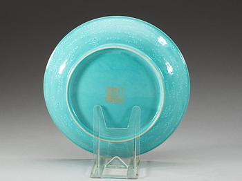 A turquoise glazed slip decorated dish, presumably late Qing dynasty with Qianlong seal mark in gold.