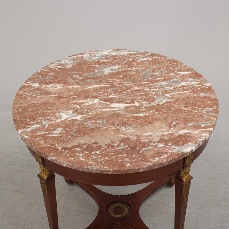 An empire-style table, early 20th century.