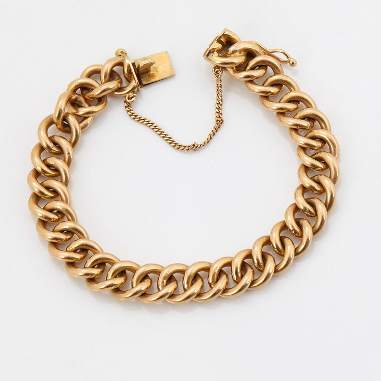 An 18K gold bracelet.