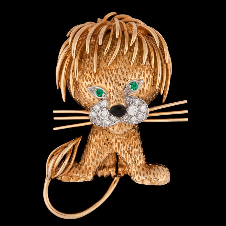 A Van Cleef & Arpels gold lion brooch set with brilliant cut diamonds and emeralds.