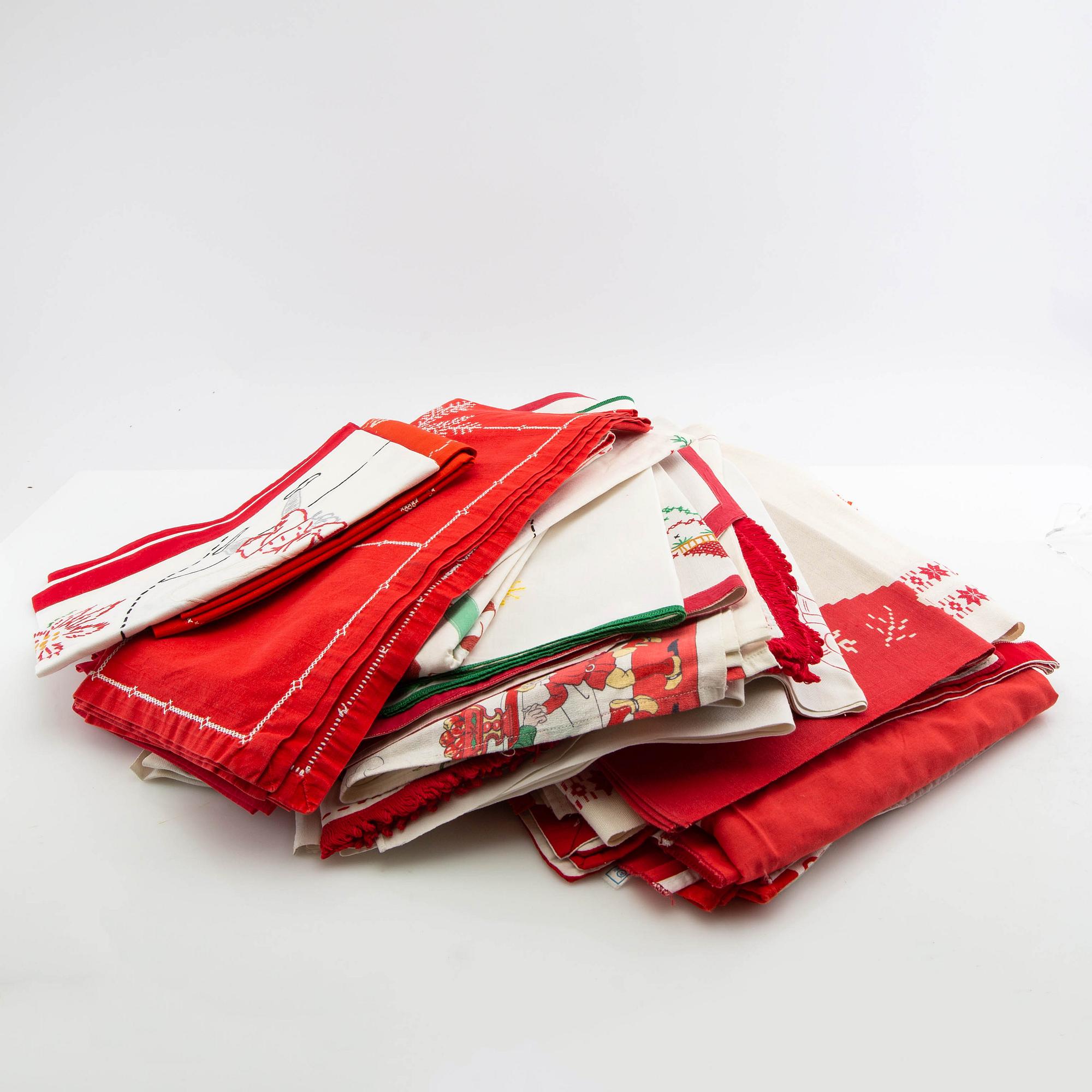 A collection of smaller Christmas tablecloths, runners, wall hangings, curtains, and Christmas tree skirts, 32 pcs, 20th century.