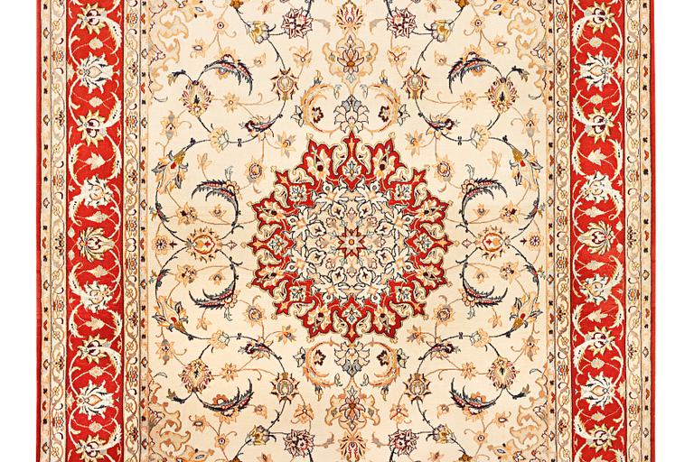 A semi-antique part silk Isfahan rug, a. 238 x 156 cm.