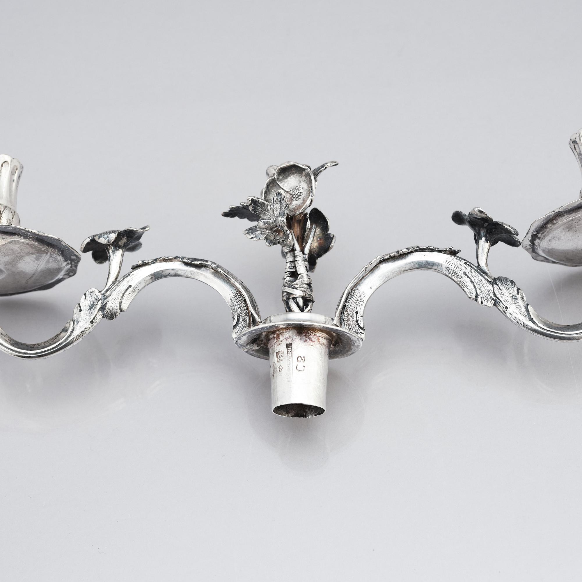 A pair of Swedish 18 century silver candelabras, mark of Lars Åkerblom Gävle 1775, arms by Christian Kullberg.
