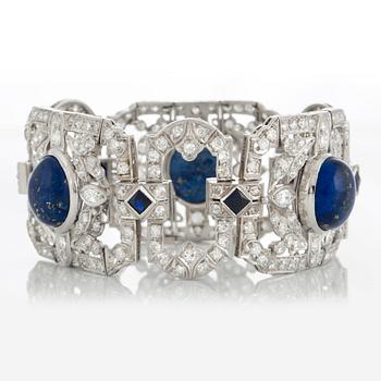 A platinum bracelet set with lapis lazuli, old-cut diamonds with a total weight of ca 10 cts and synthetic sapphires.