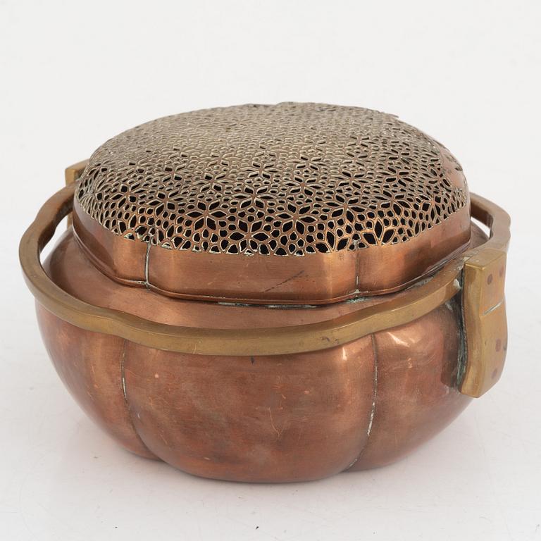 A Chinese copper handwarmer, late Qing dynasty.