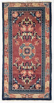 A Chinese rug, semi-antique/antique, 129 x 67 cm.