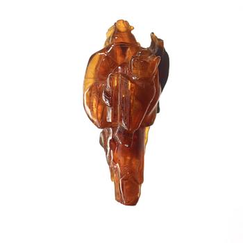 An amber figurine of a standing fisherman with prey, Qing dynasty (1644-1912).