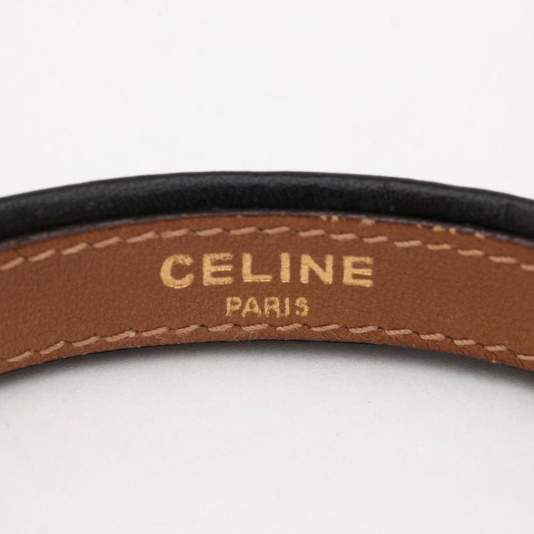 CÉLINE, a black leather bracelet.