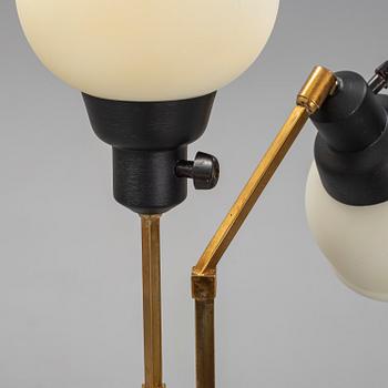 A 1950s brass and glass floor lamp.