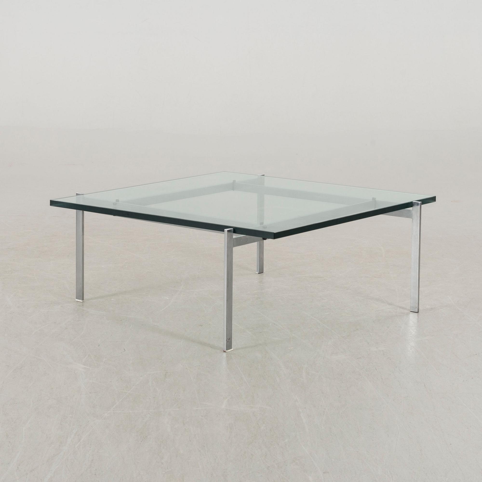 A Poul Kjaerholm PK61 glass table by Fritz Hansen.