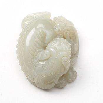 A nephrite sculpture of a reclining buddhist lion with its cub, presumably late Qing dynasty.