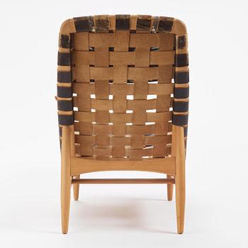 Arne Vodder, a woven leather lounge chair with attached side table, Bovirke, Denmark, 1950s.