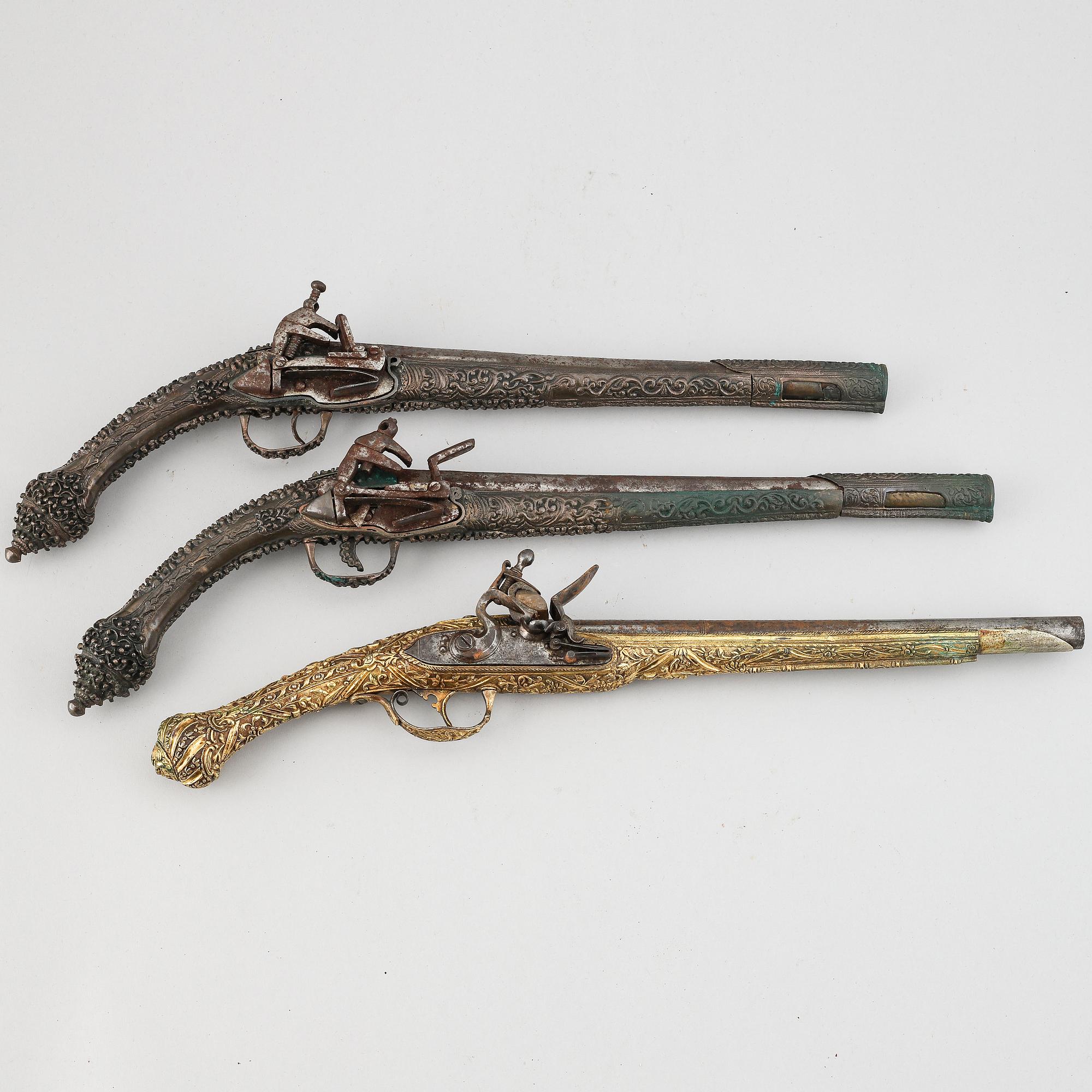 A pair of miquelet pistols and an flintlock pistol, 18/19th Century.