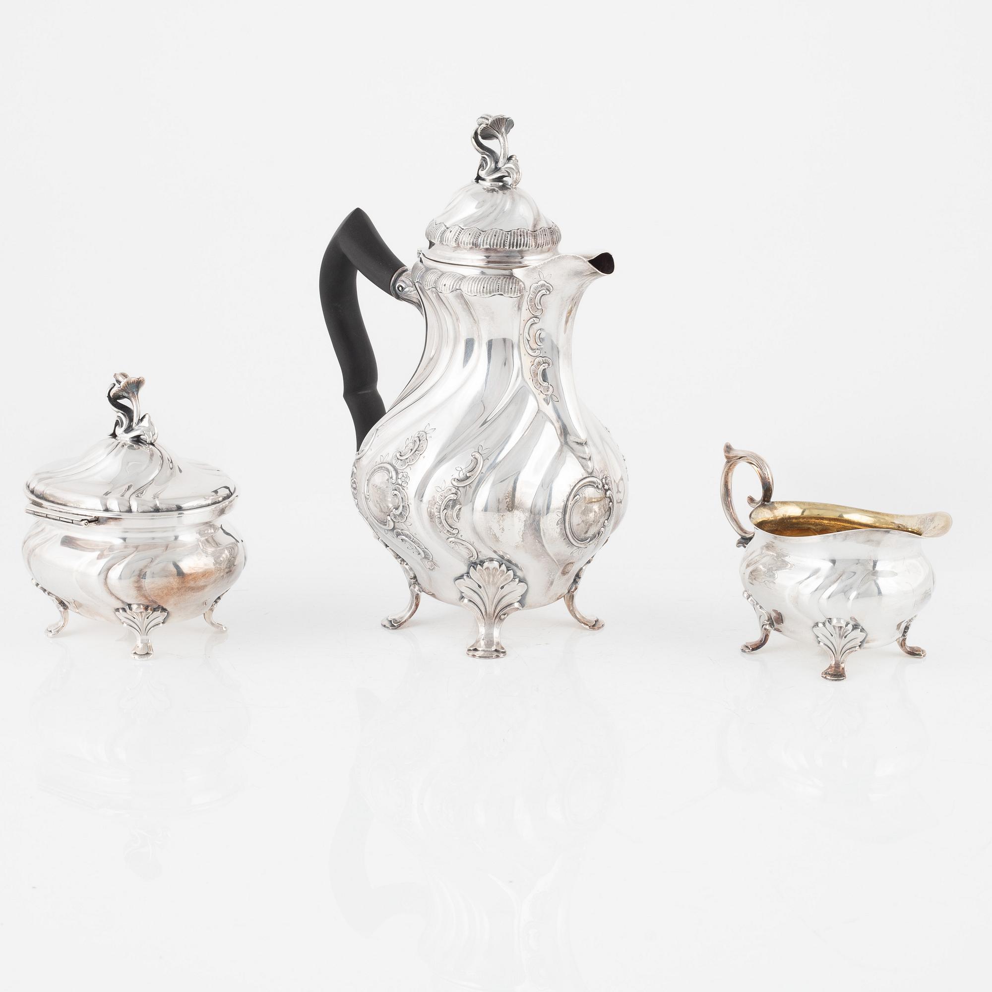 A silver coffee pot with creamer and sugarbox. CG Hallberg, Stockholm 1946.