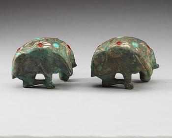 A pair of archaistic bronze figures of rams.