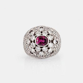 A RING set with an oval mixed-cut ruby and round brilliant- and eight-cut diamonds.